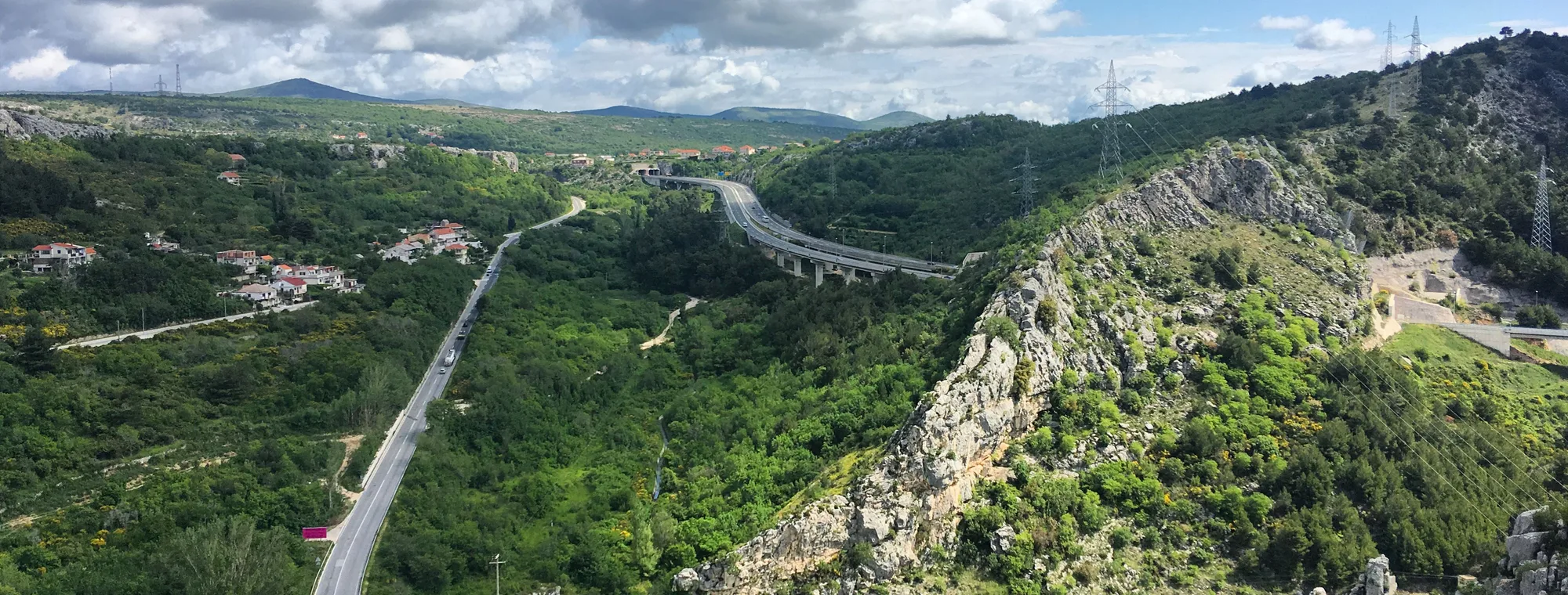 A road and viaduct cutting through a limestone gorge